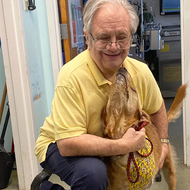 Dr. Gormley sharing a gentle moment with a dog at Highland.